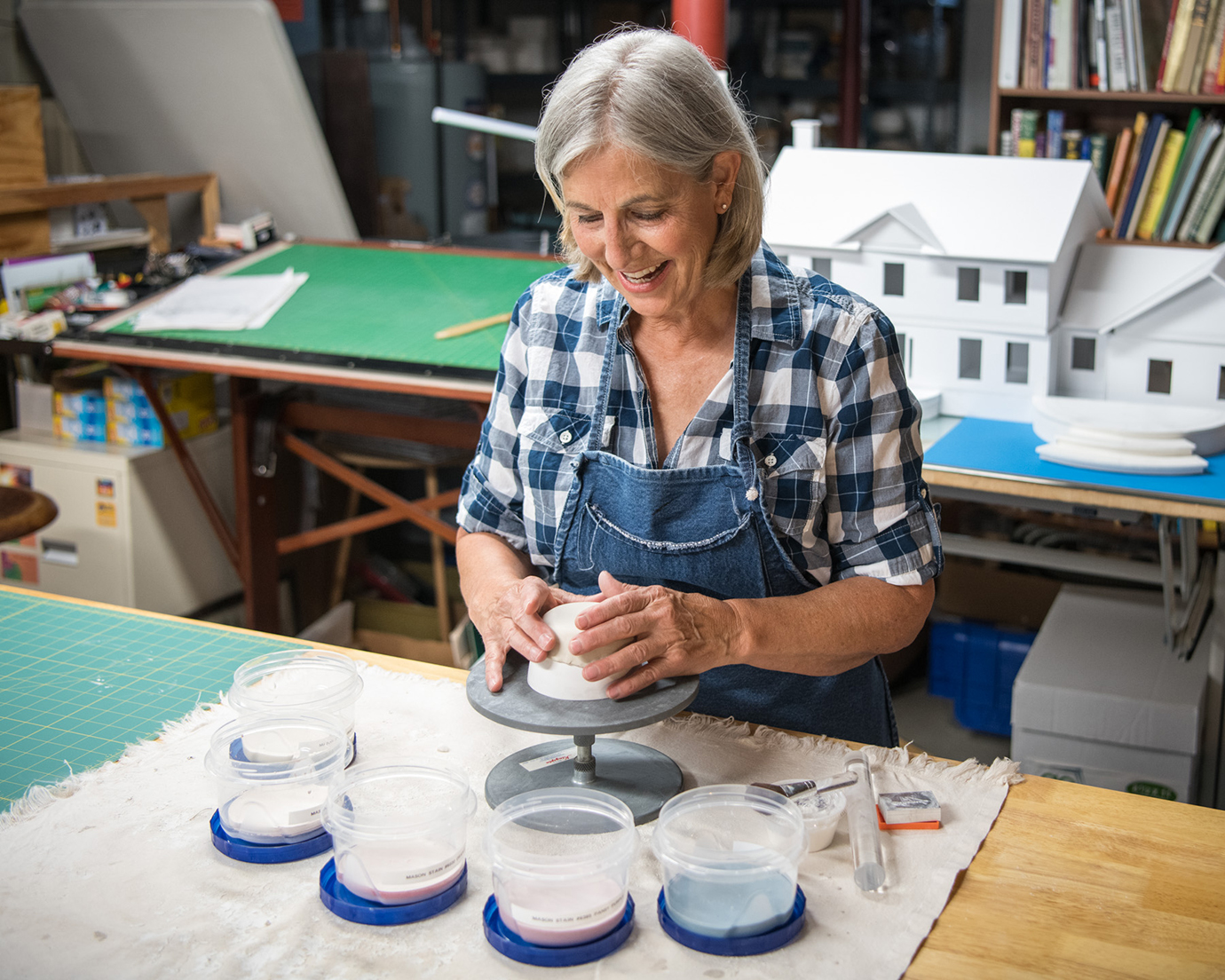 Artist working in clay in a basement studio